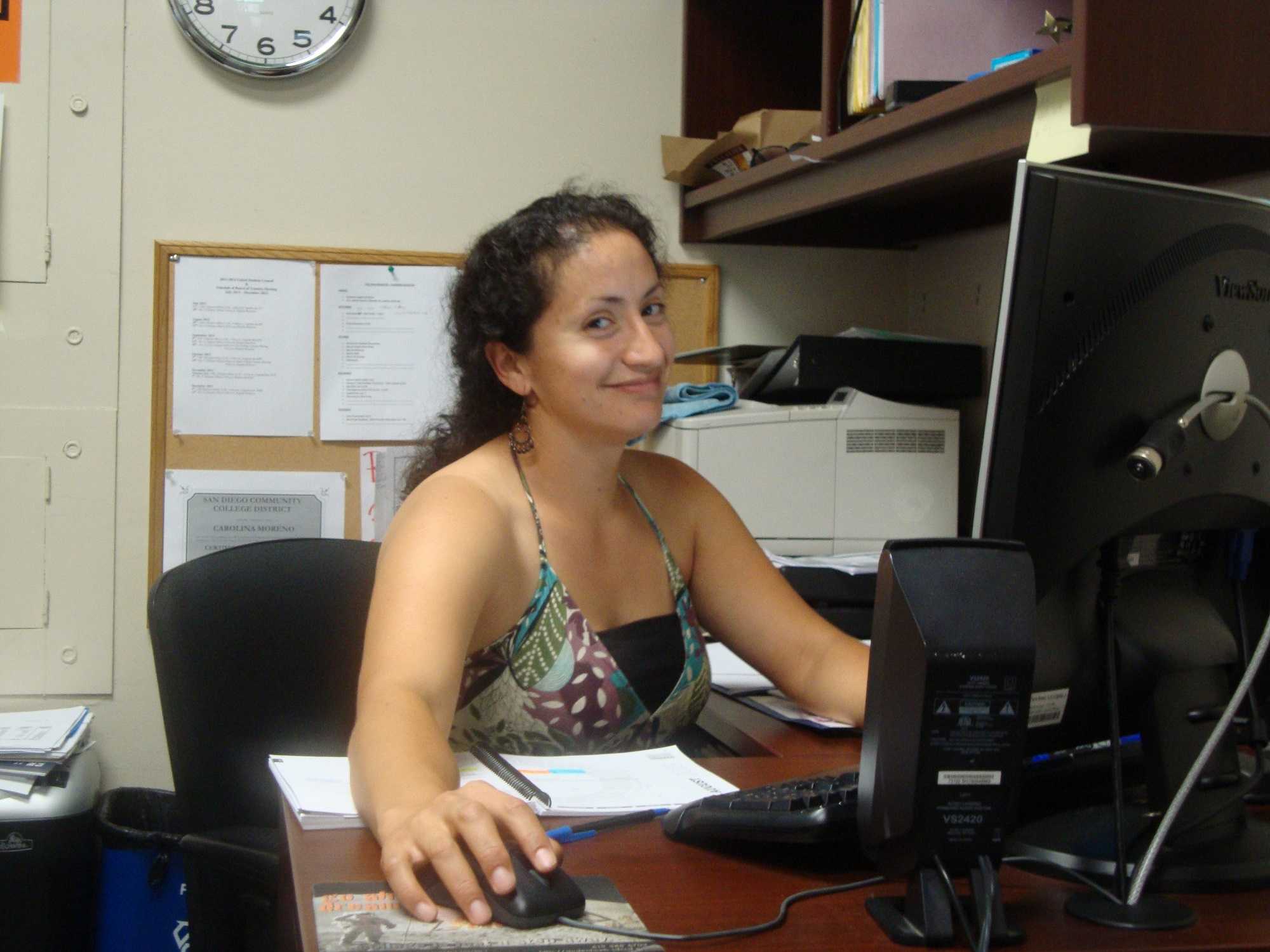 Carolina Moreno sitting at her desk. Chris Handloser, City Times.