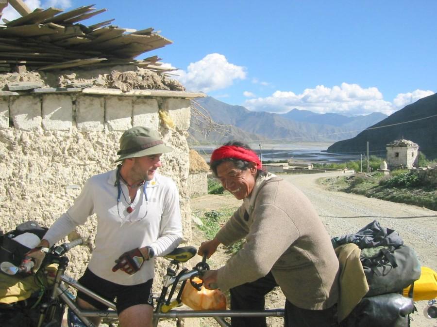 Jamie Bianchini and a passenger share a ride on his tandem bicycle in Tibet during his adventure that covered 81 countries. Photo from Abicyclebuiltfortwobillion.com