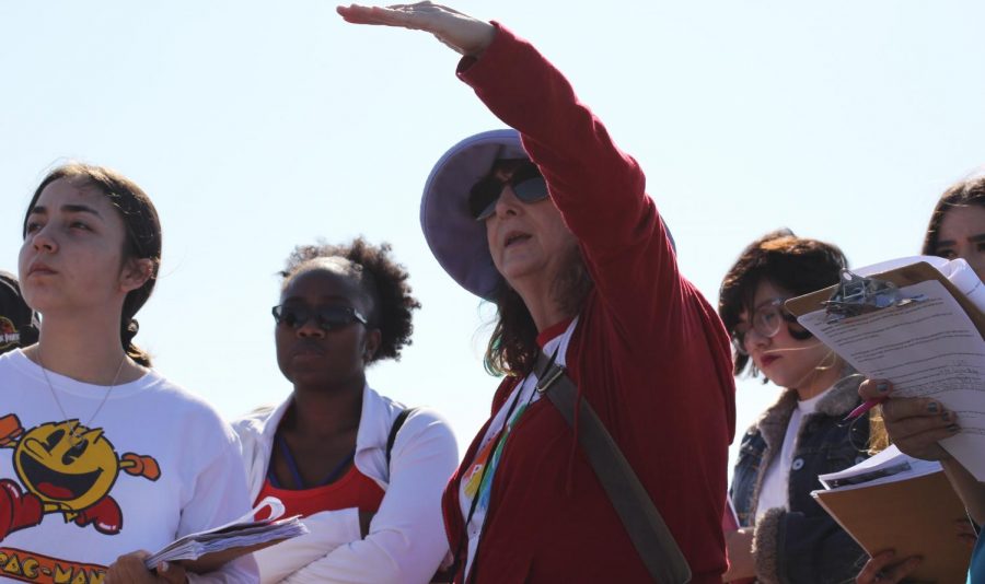 Lisa Chaddock teaches a group of students while on a hike.