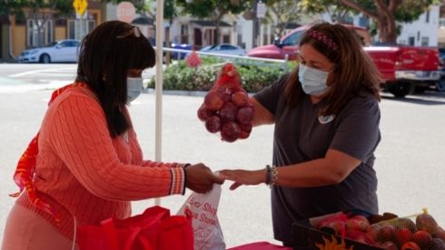 San Diego City College student receiving food from a volunteer at Hunger Action Days