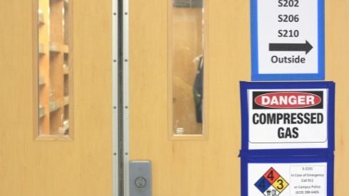 The closed lab doors of the S building at City College.