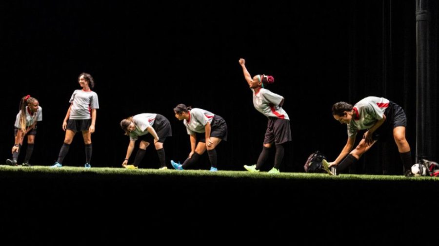 Actors stretching on stage during the play