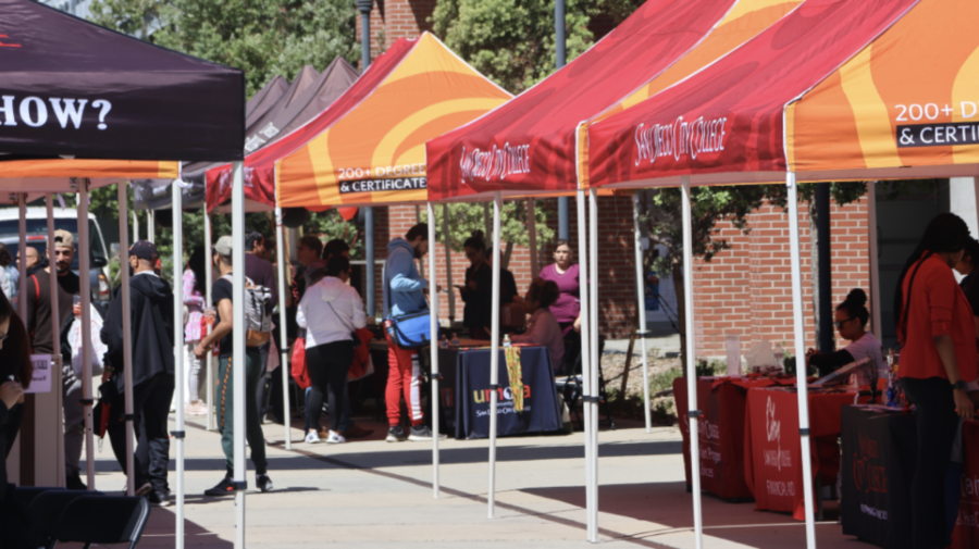 Students walking and interacting with City College department booths during Open House near the AH building at San Diego City College, April 20, 2023. Photo by Joel Nevarez/City Times Media